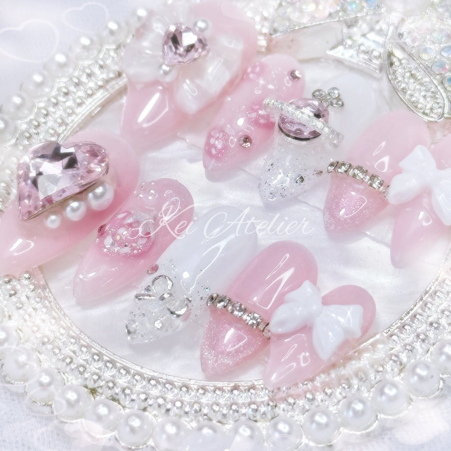Japanese style handmade press-on nail set featuring pink and white gels, 3d strawberry design, glitter, pearls, rhinestones, ribbon and bow charms, inspired by the Nana series