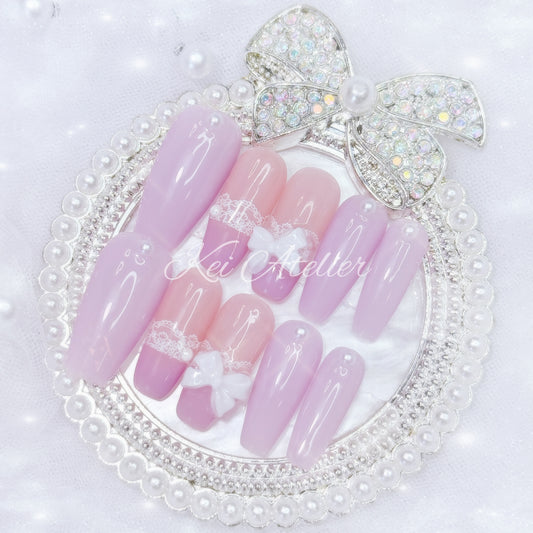 kawaii japanese ryousangata jirai coquette style handmade press-on nail set featuring solid lavender purple nails, lace adorned french tips, pearls, and bows