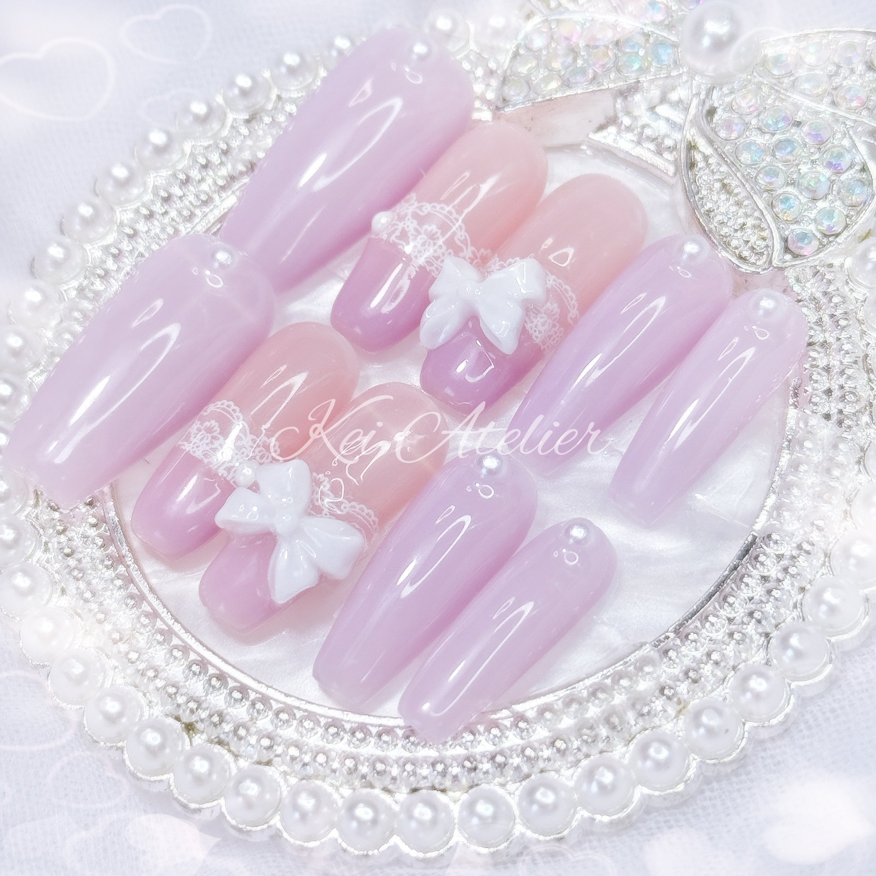 kawaii japanese ryousangata jirai coquette style handmade press-on nail set featuring solid lavender purple nails, lace adorned french tips, pearls, and bows