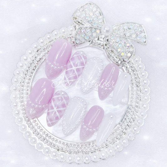 kawaii japanese ryousangata jirai coquette style handmade press-on nail set featuring lavender purple and white gels, a lattice pattern, and pearls lining the french tips and boarders