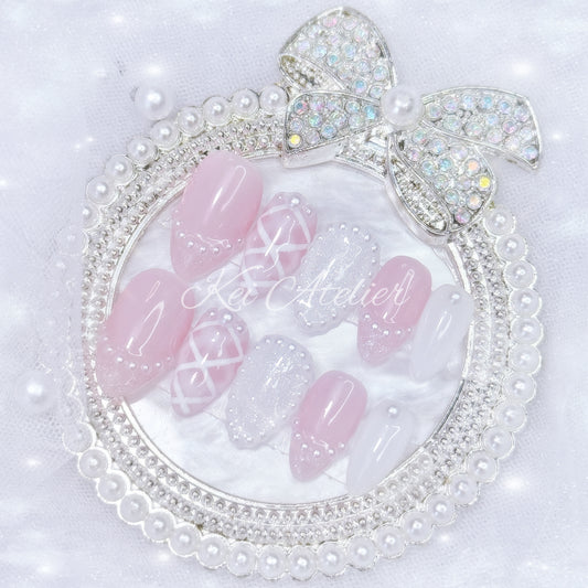 kawaii japanese ryousangata jirai coquette style handmade press-on nail set featuring pink and white gels, a lattice pattern, and pearls lining the french tips and boarders
