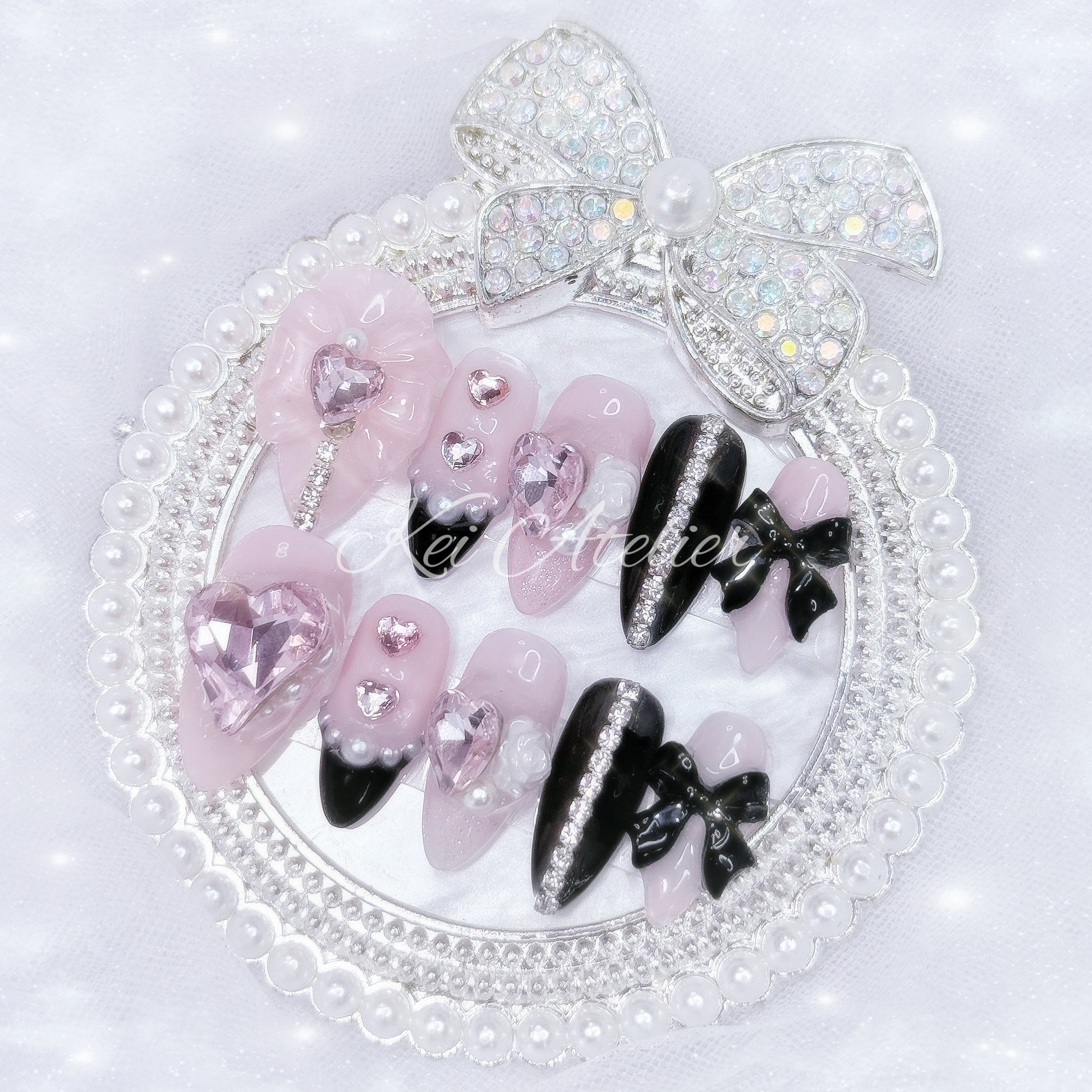 Kawaii Japanese ryousangata jirai style handmade press-on nail set featuring pink and black gels, glitter, pearls, heart bijoux, rhinestones, bows and ribbons