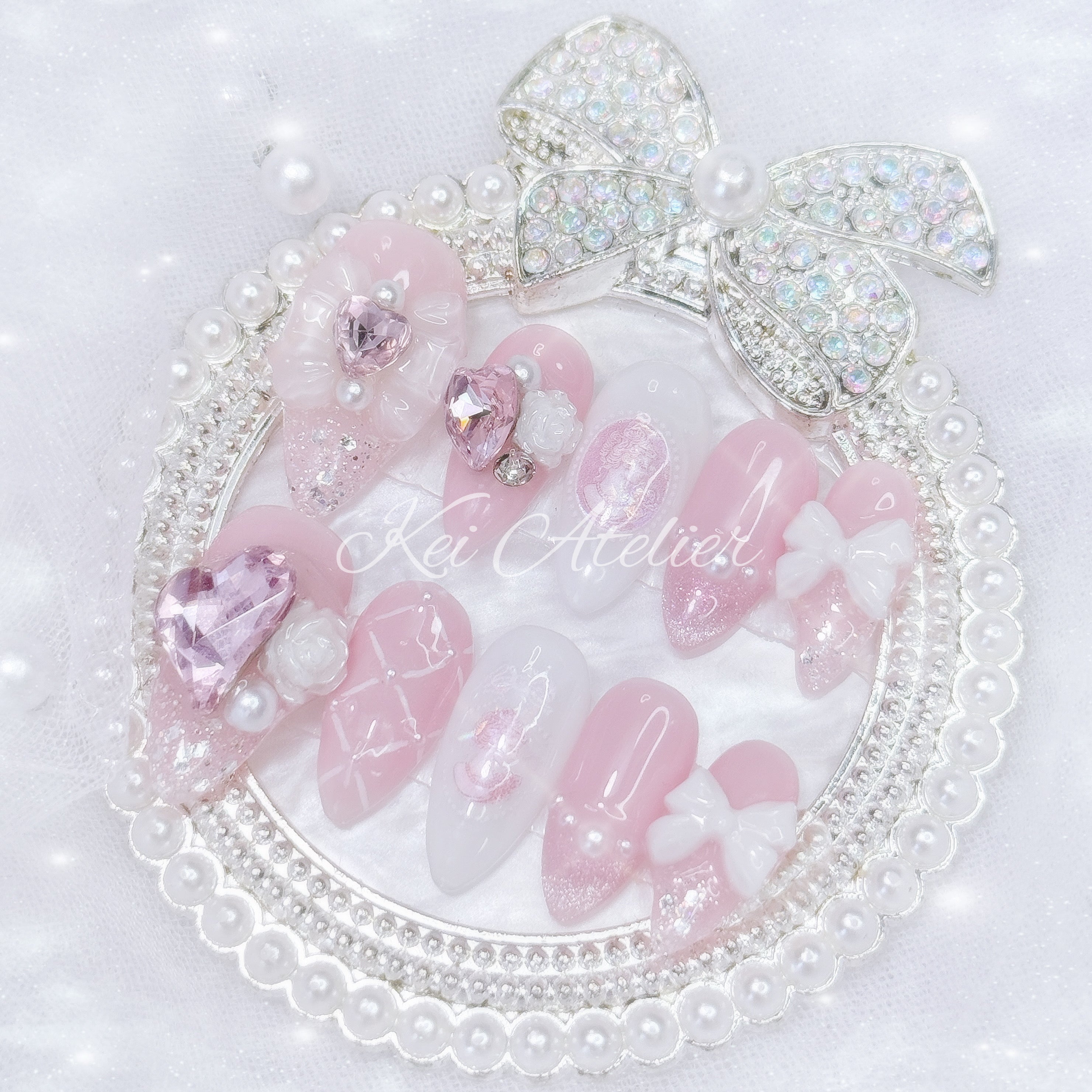 Kawaii Japanese ryousangata jirai style handmade press-on nail set featuring pink and white gels, decorated with ribbons, bows, roses, princess silhouette sticker, pearls, cat eye french tip, and lattice design. inspired by rose of versailles marie Antoinette