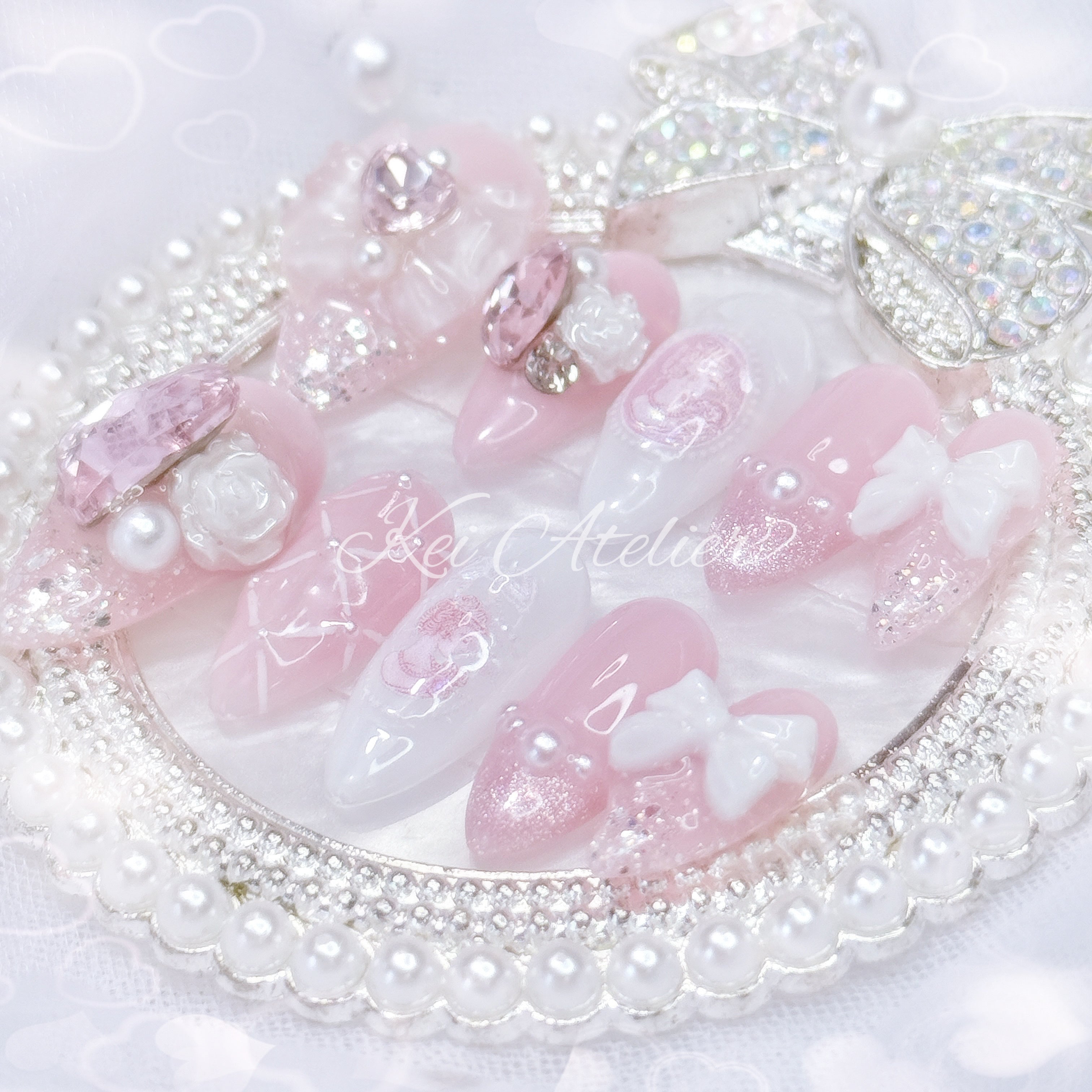 Kawaii Japanese ryousangata jirai style handmade press-on nail set featuring pink and white gels, decorated with ribbons, bows, roses, princess silhouette sticker, pearls, cat eye french tip, and lattice design. inspired by rose of versailles marie Antoinette