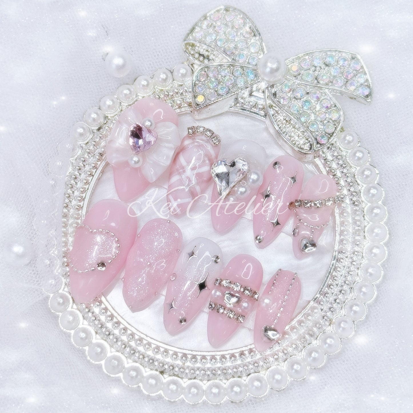 Kawaii Japanese ryousangata jirai style handmade press-on nail set featuring pink and white gels, argyle plaid pattern, 3d cushion art, glitter, shimmer, sparkles, starlight, heart crystals and rhinestones, and a bow