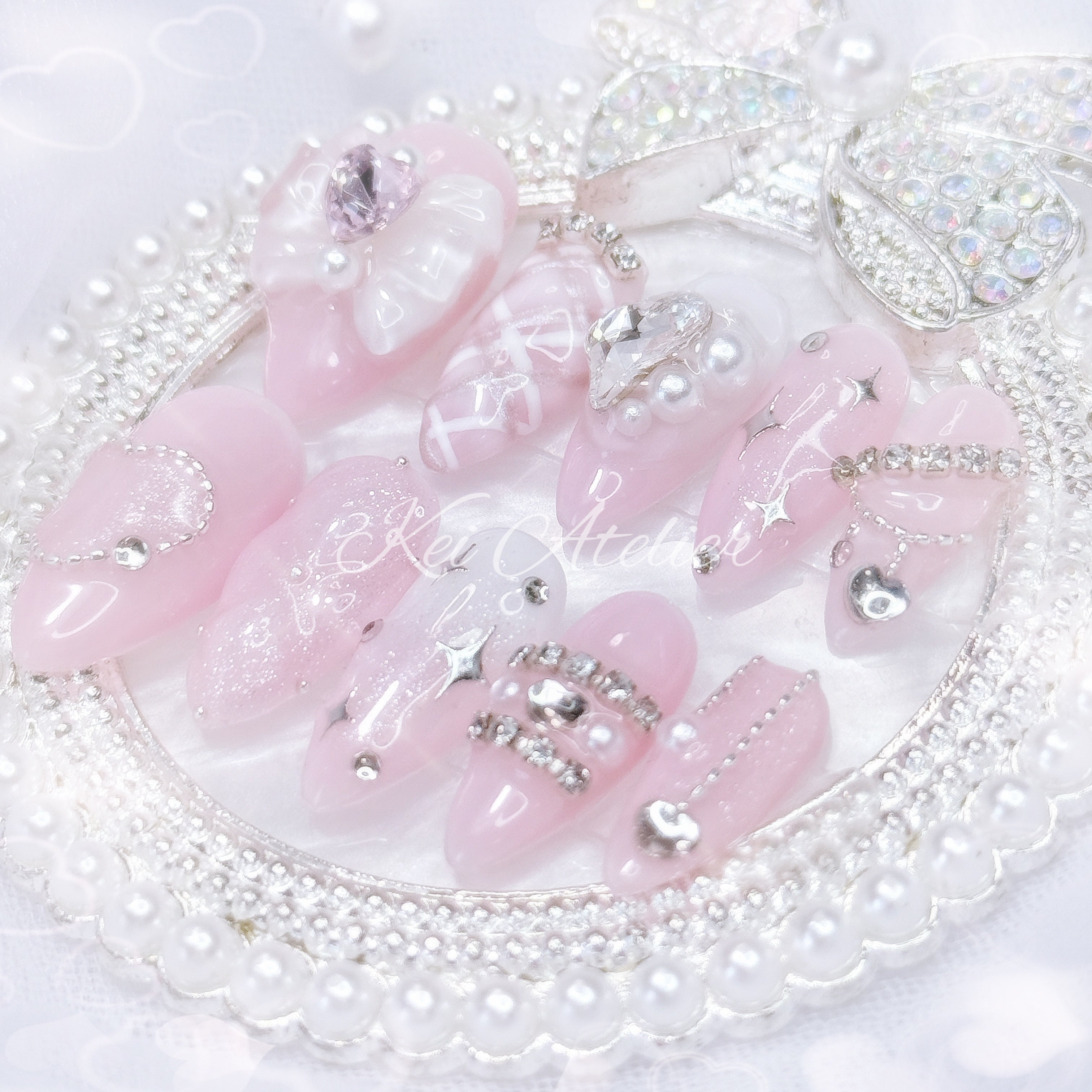 Kawaii Japanese ryousangata jirai style handmade press-on nail set featuring pink and white gels, argyle plaid pattern, 3d cushion art, glitter, shimmer, sparkles, starlight, heart crystals and rhinestones, and a bow