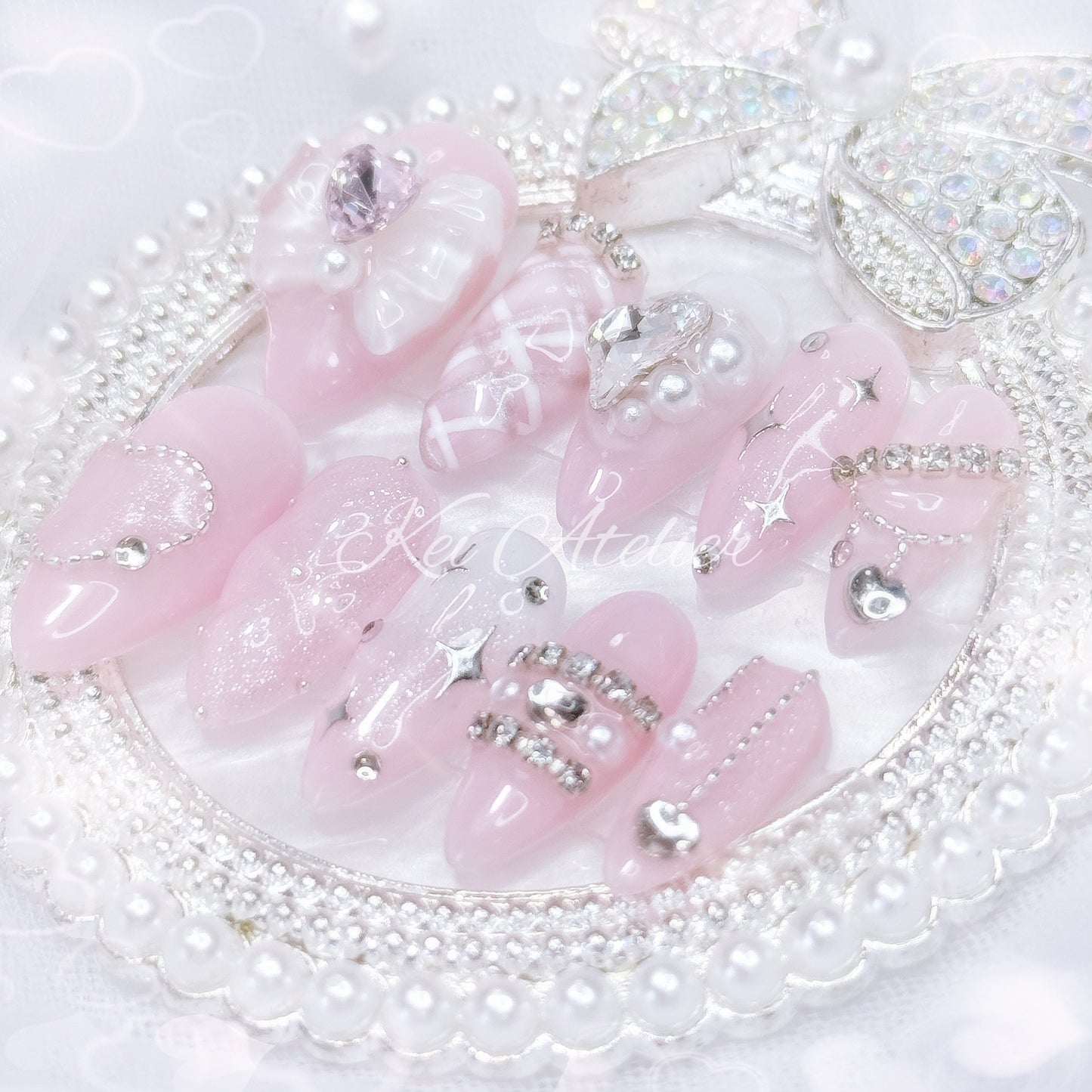 Kawaii Japanese ryousangata jirai style handmade press-on nail set featuring pink and white gels, argyle plaid pattern, 3d cushion art, glitter, shimmer, sparkles, starlight, heart crystals and rhinestones, and a bow