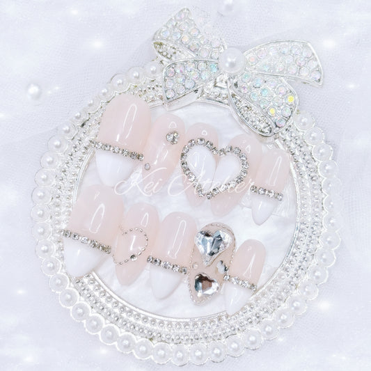 kawaii japanese ryousangata jirai coquette style handmade press-on nail set featuring nude gel and white french tips, with heart motifs and bijoux rhinestone crystals