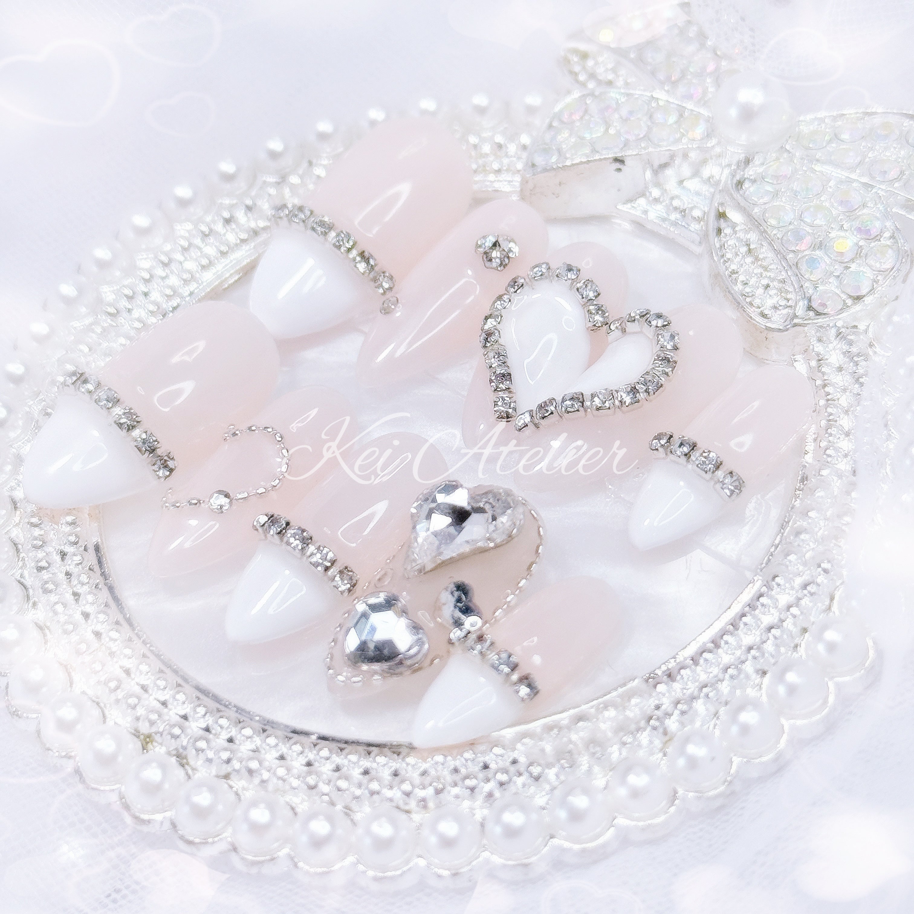 kawaii japanese ryousangata jirai coquette style handmade press-on nail set featuring nude gel and white french tips, with heart motifs and bijoux rhinestone crystals