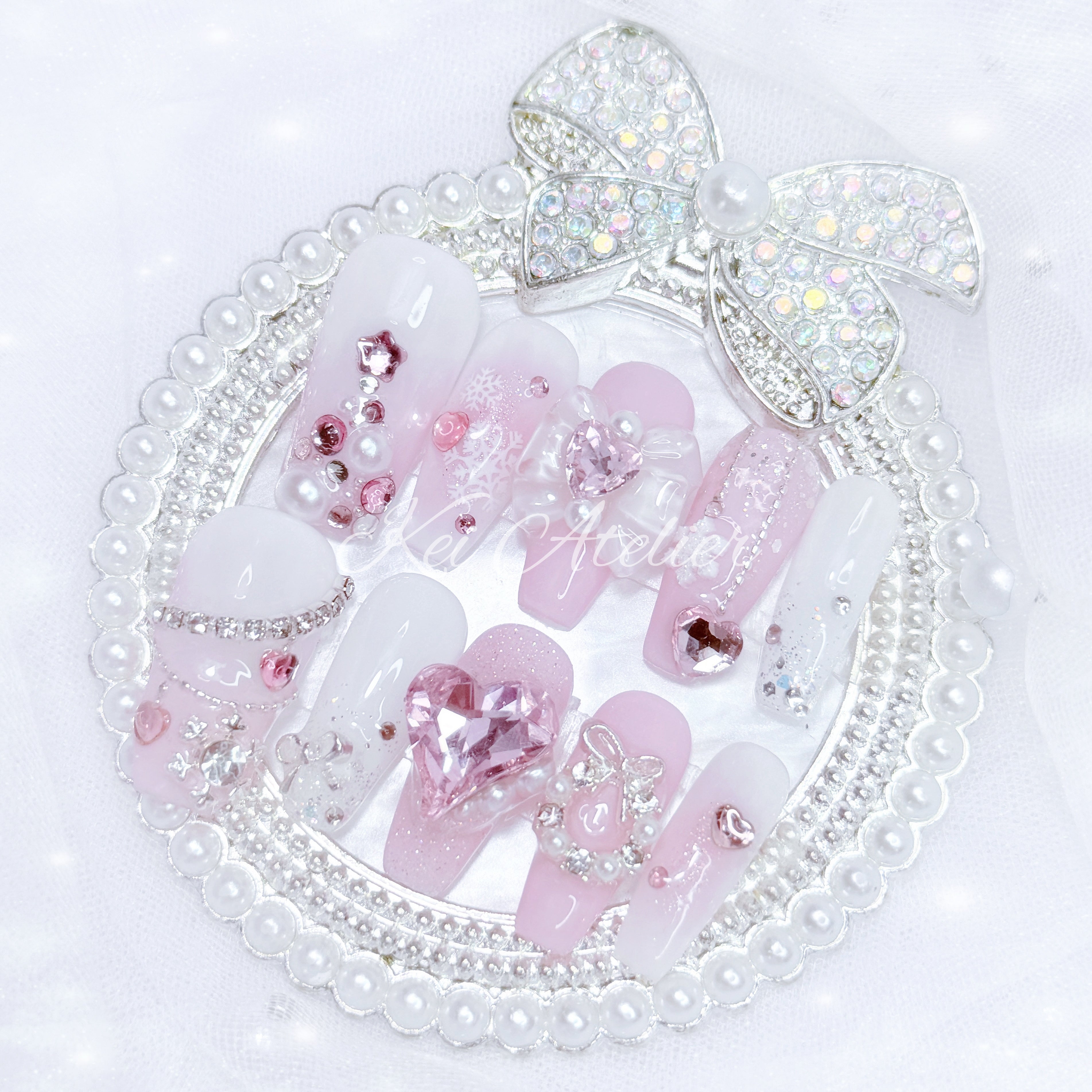 pink and white ryousangata style nail set, pink christmas holiday season limited edition set. features snowflakes, rhinestones pink and white ombre, wreath, ribbons, hearts, bows, christmas tree made with rhinestones, and other decorations. custom handmade by kei atelier