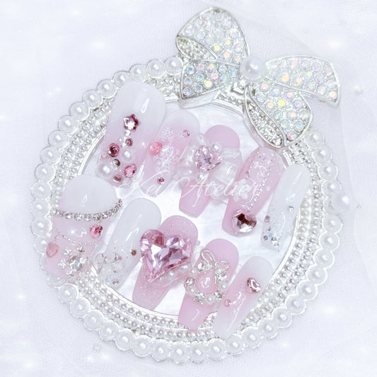 pink and white ryousangata style nail set, pink christmas holiday season limited edition set. features snowflakes, rhinestones pink and white ombre, wreath, ribbons, hearts, bows, christmas tree made with rhinestones, and other decorations. custom handmade by kei atelier