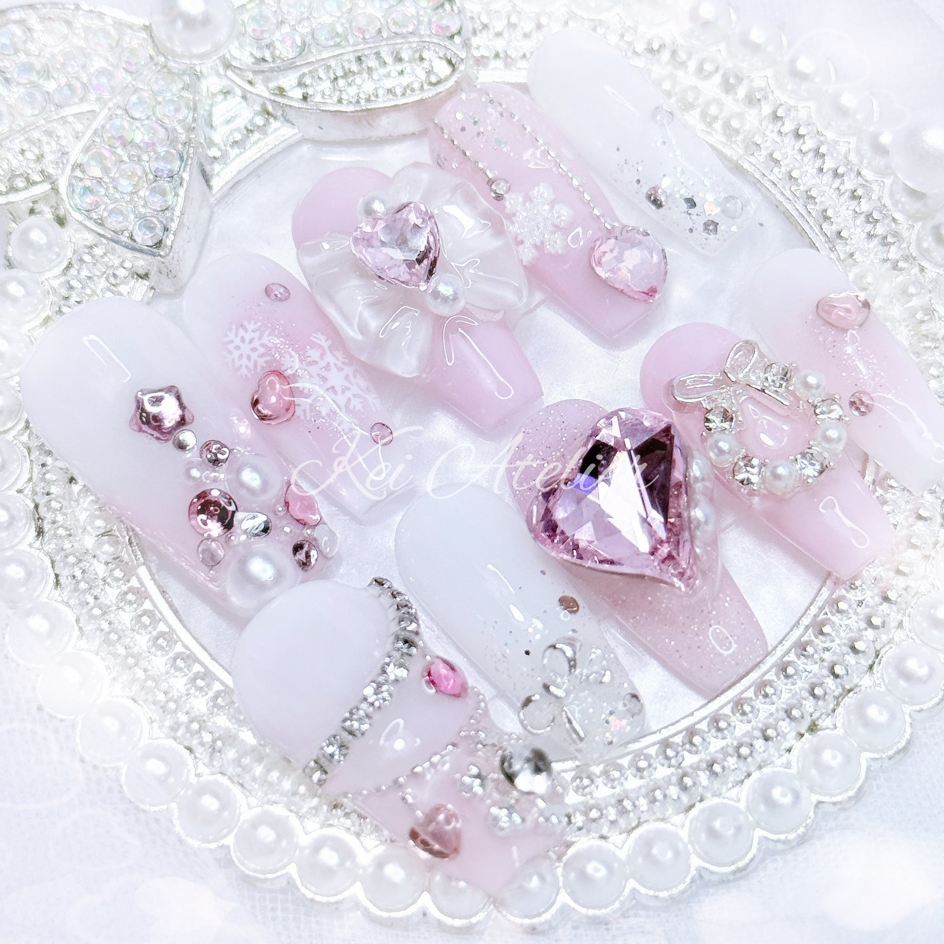 pink and white ryousangata style nail set, pink christmas holiday season limited edition set. features snowflakes, rhinestones pink and white ombre, wreath, ribbons, hearts, bows, christmas tree made with rhinestones, and other decorations. custom handmade by kei atelier
