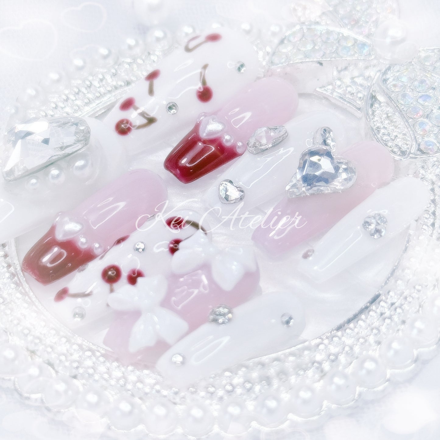 kawaii japanese ryousangata jirai gyaru style handmade press-on nail set featuring pink, white, and cherry red jelly gels, bejeweled in heart crystal rhinestone charms, white bows, pearls, and hand-painted cherries, perfect for summer, bold yet soft