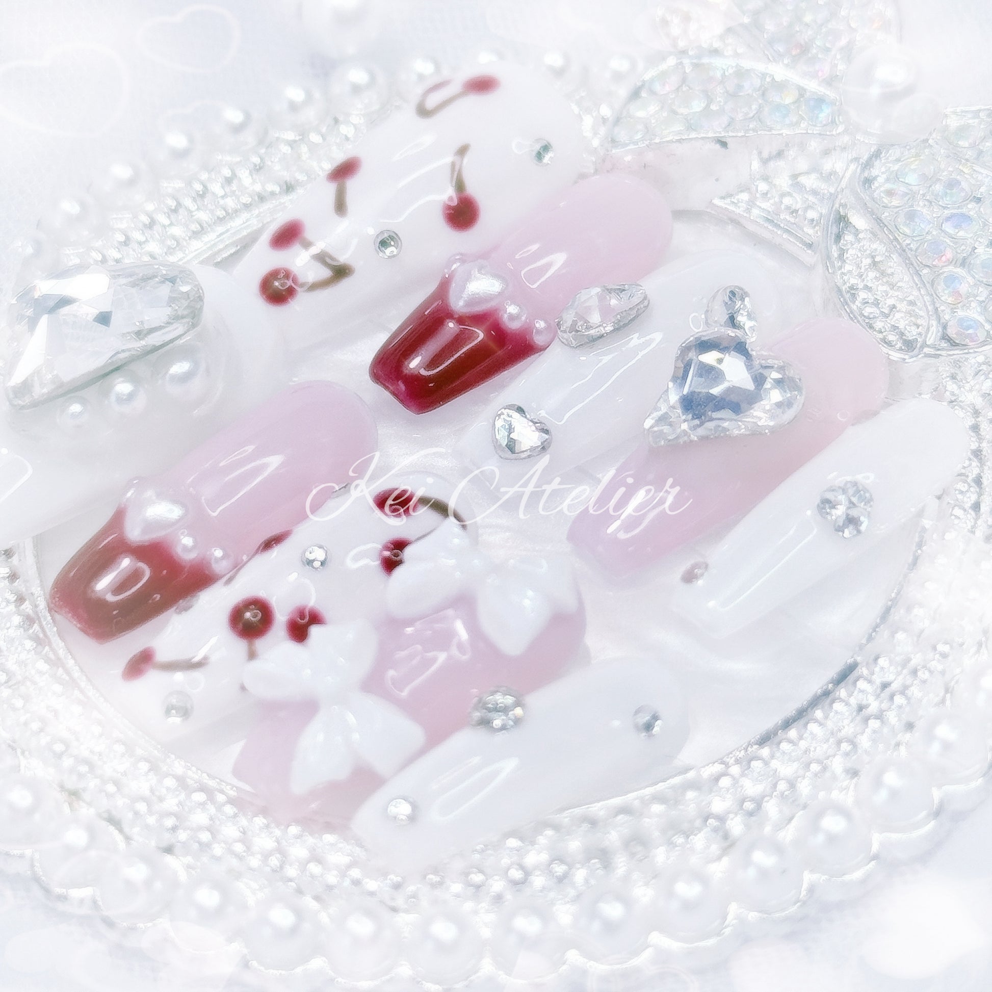 kawaii japanese ryousangata jirai gyaru style handmade press-on nail set featuring pink, white, and cherry red jelly gels, bejeweled in heart crystal rhinestone charms, white bows, pearls, and hand-painted cherries, perfect for summer, bold yet soft
