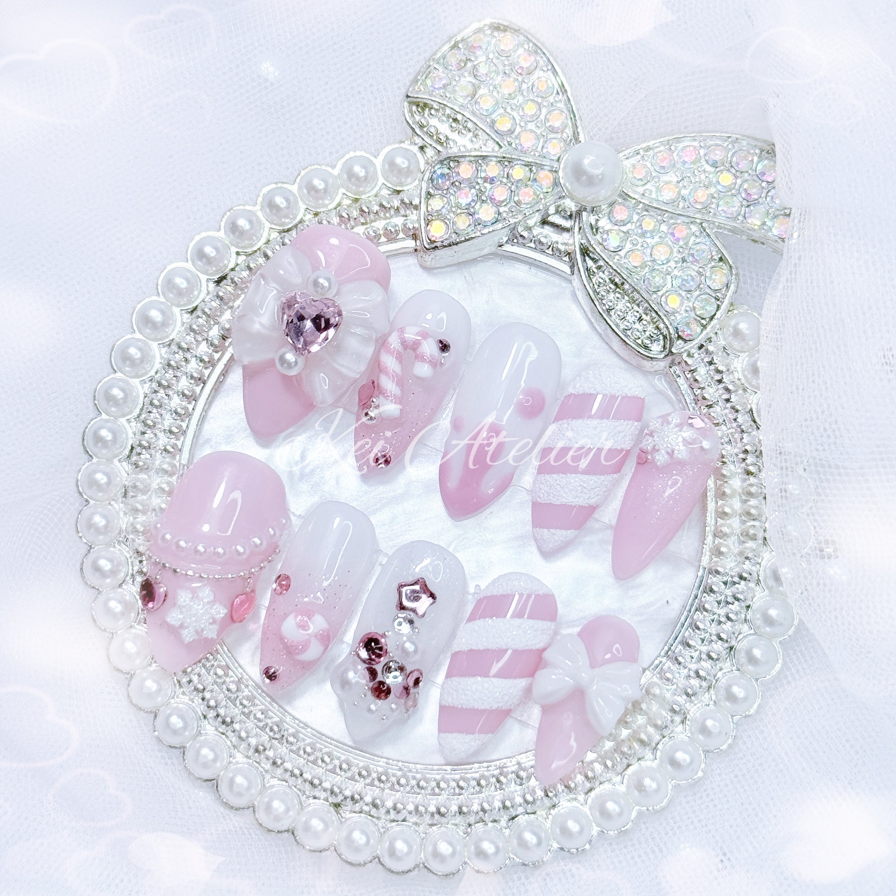 pink and white ryousangata style candy cane nail set, pink christmas holiday season limited edition set. features snowflakes, rhinestones pink and white ombre, ribbons, hearts, bows, christmas tree made with rhinestones, handmade candy cane and peppermint charms, sugary candy design, and other decorations. custom handmade by kei atelier