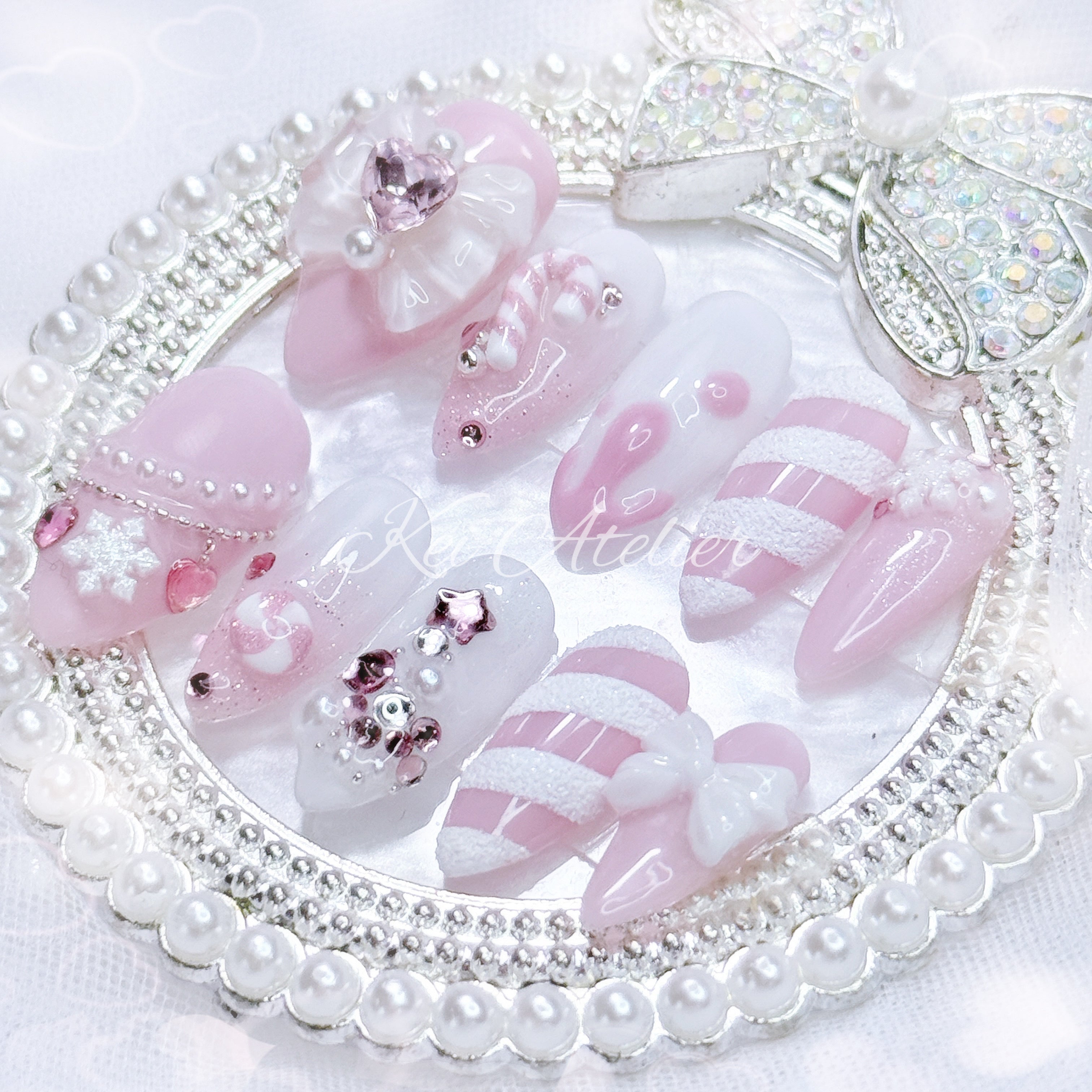 pink and white ryousangata style candy cane nail set, pink christmas holiday season limited edition set. features snowflakes, rhinestones pink and white ombre, ribbons, hearts, bows, christmas tree made with rhinestones, handmade candy cane and peppermint charms, sugary candy design, and other decorations. custom handmade by kei atelier