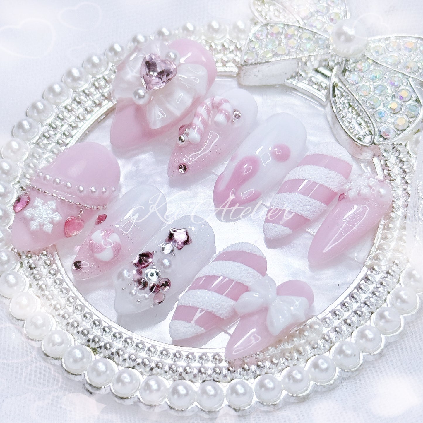 pink and white ryousangata style candy cane nail set, pink christmas holiday season limited edition set. features snowflakes, rhinestones pink and white ombre, ribbons, hearts, bows, christmas tree made with rhinestones, handmade candy cane and peppermint charms, sugary candy design, and other decorations. custom handmade by kei atelier