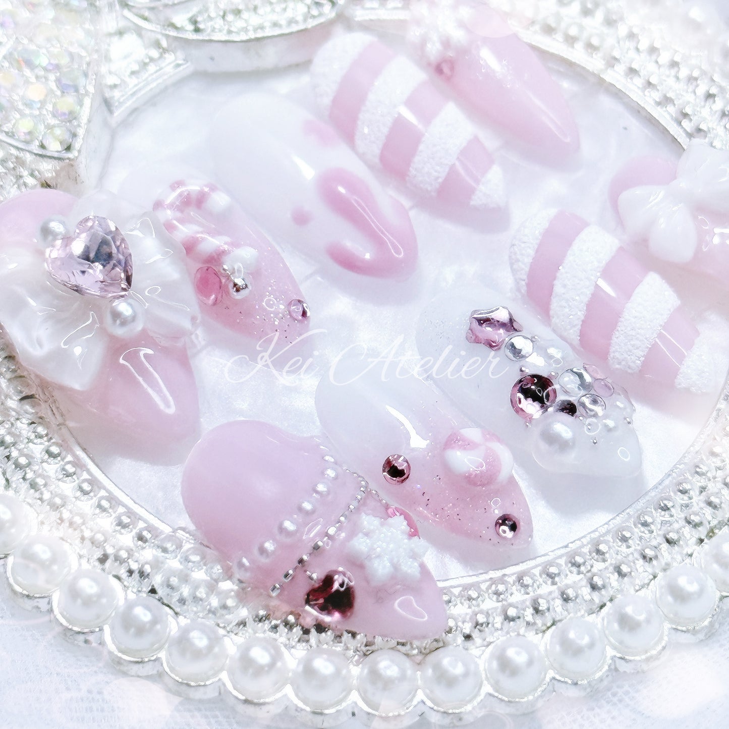 pink and white ryousangata style candy cane nail set, pink christmas holiday season limited edition set. features snowflakes, rhinestones pink and white ombre, ribbons, hearts, bows, christmas tree made with rhinestones, handmade candy cane and peppermint charms, sugary candy design, and other decorations. custom handmade by kei atelier
