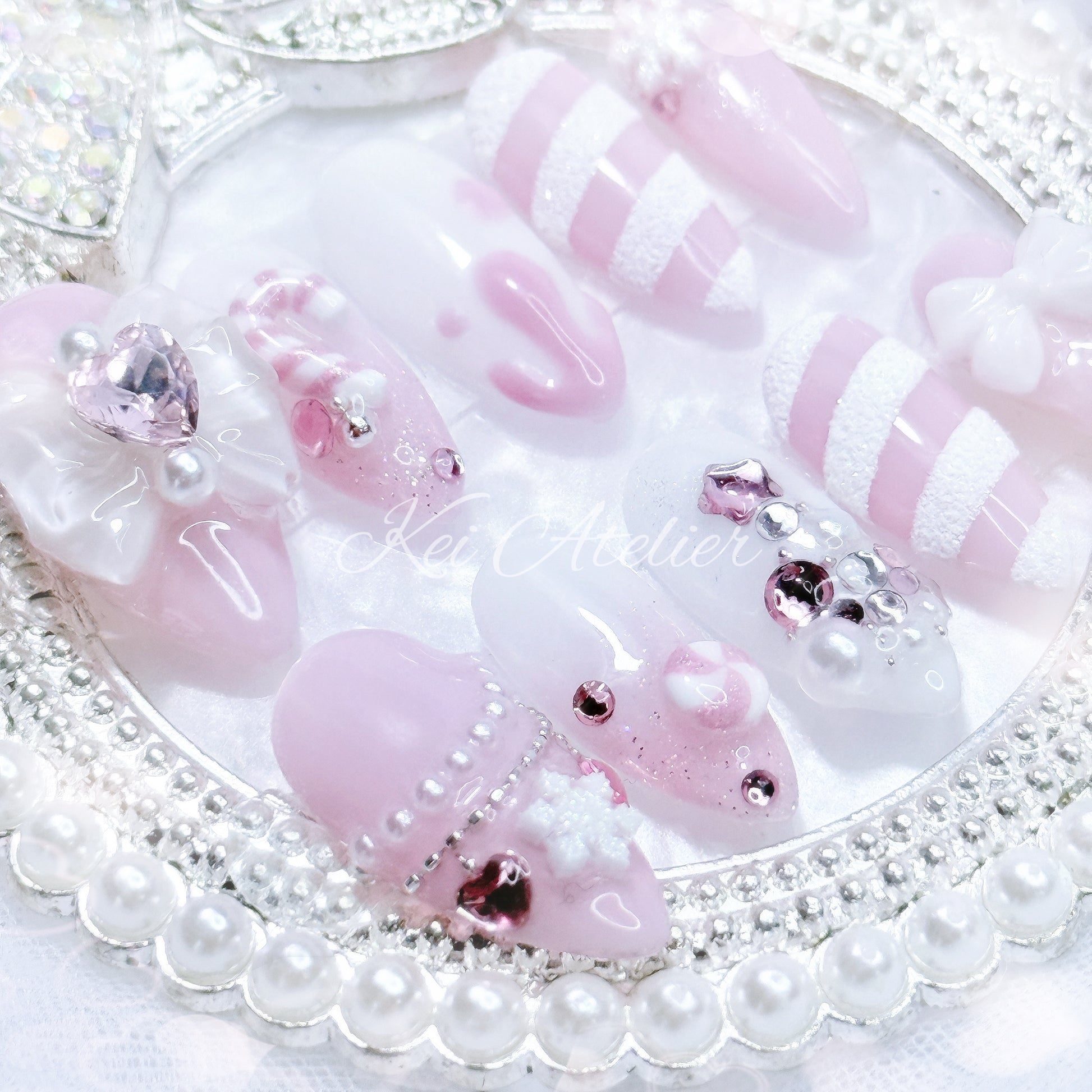 pink and white ryousangata style candy cane nail set, pink christmas holiday season limited edition set. features snowflakes, rhinestones pink and white ombre, ribbons, hearts, bows, christmas tree made with rhinestones, handmade candy cane and peppermint charms, sugary candy design, and other decorations. custom handmade by kei atelier