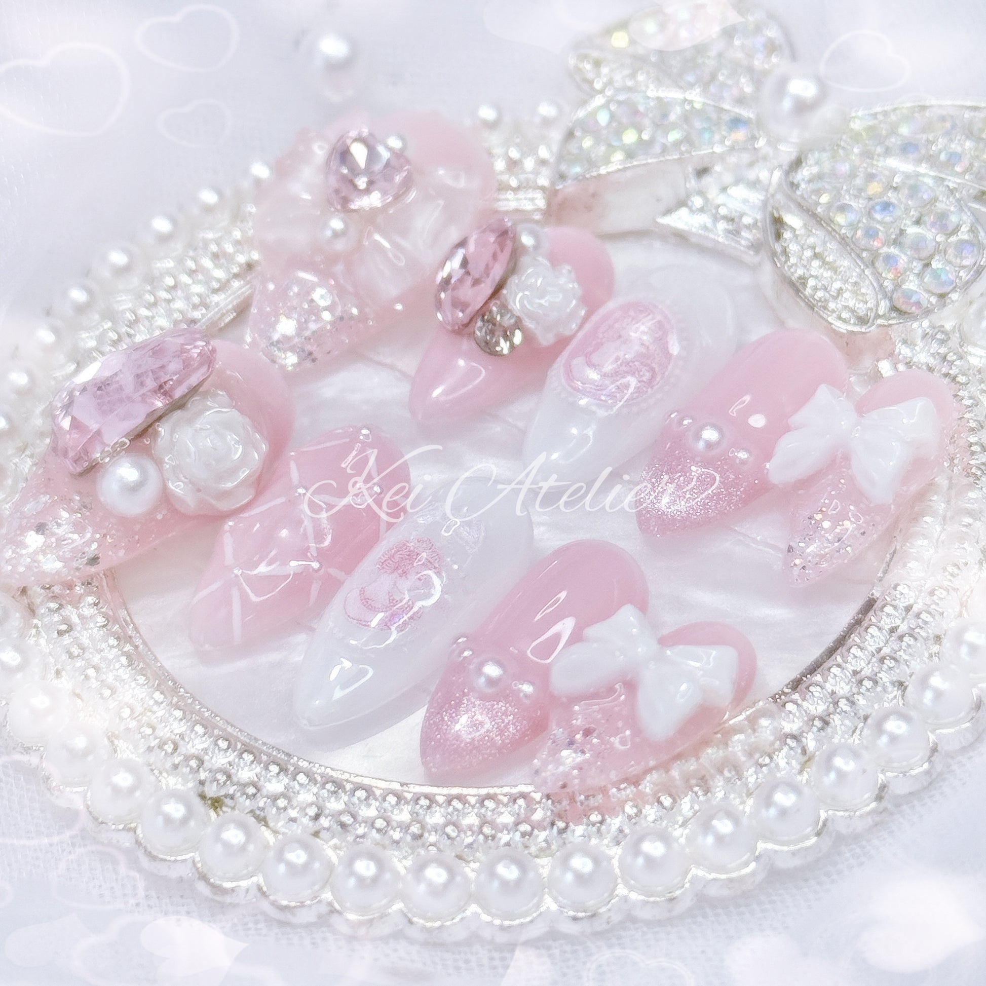 Kawaii Japanese ryousangata jirai style handmade press-on nail set featuring pink and white gels, decorated with ribbons, bows, roses, princess silhouette sticker, pearls, cat eye french tip, and lattice design. inspired by rose of versailles marie Antoinette 