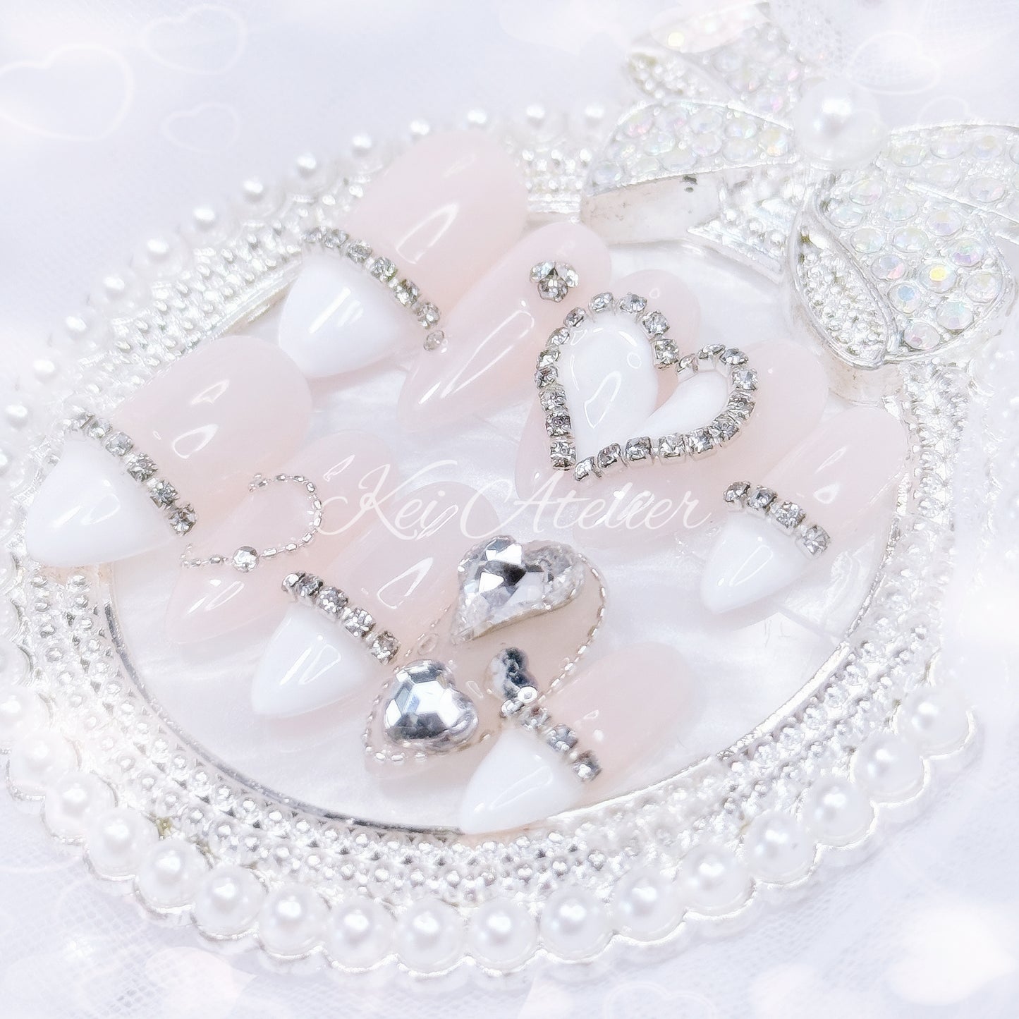 kawaii japanese ryousangata jirai coquette style handmade press-on nail set featuring nude gel and white french tips, with heart motifs and bijoux rhinestone crystals