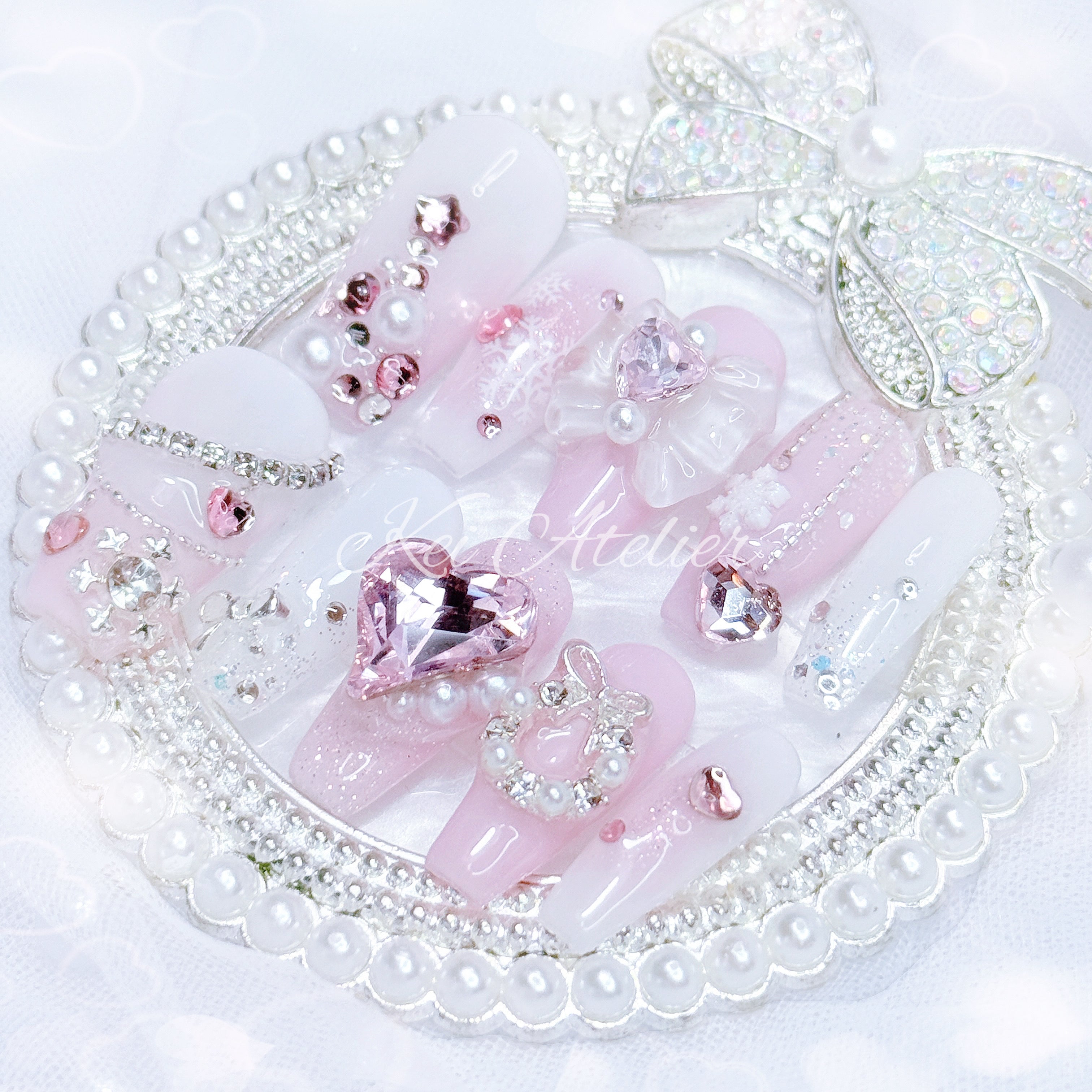 pink and white ryousangata style nail set, pink christmas holiday season limited edition set. features snowflakes, rhinestones pink and white ombre, wreath, ribbons, hearts, bows, christmas tree made with rhinestones, and other decorations. custom handmade by kei atelier
